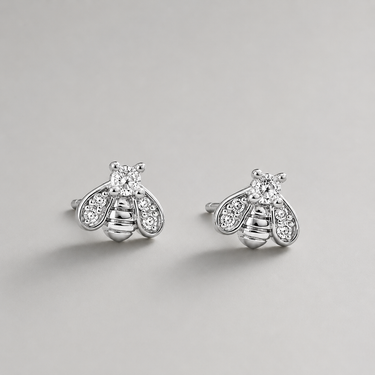 Silver bee-shaped earrings with gemstones on a light gray background