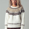 Back view of Zermatt Sweater, fair isle knit in cream with taupe and brown yoke, styled with brown pants.