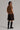 Back view of the Addit brown knit top styled with shorts.