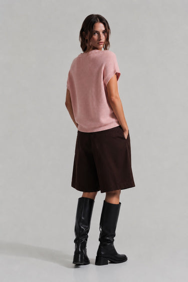 Back view of the Addit blush pink knit top styled with shorts.