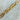 Adeline gold plated rectangular link chain necklace draped on stone vase