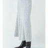 Full-length view of the Aero knit maxi skirt styled with black boots.