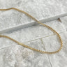 Albacete Necklace by Matte, gold plated chain necklace displayed on marble tile background