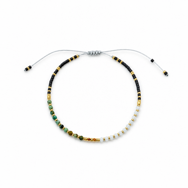 Close-up product photo of the Amaris Bracelet showing multicolor turquoise, white, black, and gold beads on an adjustable braided cord with sliding knot closure.