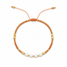 Amatilde Bracelet with terracotta beads, pearl accents, gold details, and adjustable sliding closure.