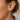 Model wearing Amel Stud Earrings gold crystal wing stud earrings in ear close-up.
