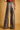Amelti multicolor striped pants with back patch pockets and wide legs, rear view.