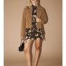 Model wearing the Amirk Jacket over a black floral mini dress, showing the full outfit styling and versatile day-to-night look.