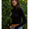 Amit Top black turtleneck fitted crop top side view showing long sleeves and sculpted fit