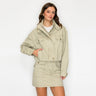 Model wearing the Amurai Utility Cropped Jacket in light khaki with a relaxed fit and flap pockets.