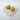 Anderlecht gold plated heart stud earrings on white stone background