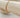Atela Bracelet gold plated square link chain displayed on wood bar