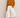 Banana Bloom Crochet Top yellow long sleeve crochet knit top worn with white skirt, showing relaxed fit and bold banana pattern.