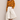 Banana Bloom Crochet Top yellow long sleeve crochet knit top worn with white skirt, showing relaxed fit and bold banana pattern.
