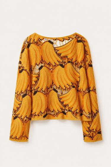 Banana Bloom Crochet Top flat lay showing golden yellow color, long sleeves, and textured crochet pattern.