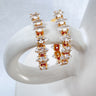 Beltaine gold plated cubic zirconia stud earrings on display by Matte