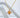 Beril Necklace by Matte, gold plated sunburst star pendant on chain, styled on white sculptural background