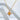 Beril Necklace by Matte, gold plated sunburst star pendant on chain, styled on white sculptural background