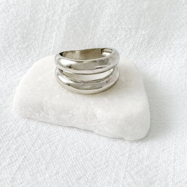 Silver double-band statement ring with sculptural shape on marble base – Big Shot Ring by Matte.