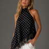 Bishop Top featuring a black silky sleeveless blouse with white polka dots, delicate lace trim, and a high neckline.