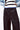 Waist detail of Lisboa Pants with button and pleated front.