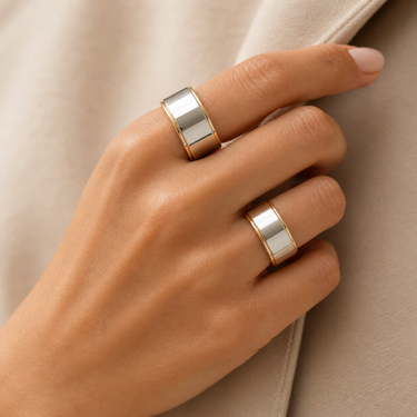 Bolty Ring worn on hand with stacked rings, showing chunky two-tone band design and polished finish.