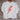 Bono Tee — white cropped t-shirt with bold red lightning bolt graphic, styled hanging on wooden hanger against rustic wall background.