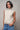 Front view of the Boon sleeveless knit top in ivory featuring crystal shoulder detailing and a mock neckline.