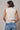 Back view of the Boon sleeveless mock-neck sweater in ivory showing the clean silhouette.