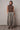 Full-body view of the Boon brown knit top styled with a printed pants for an elevated everyday outfit.
