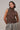 Three-quarter view of the Boon brown sleeveless sweater highlighting the crystal shoulder details and relaxed fit.