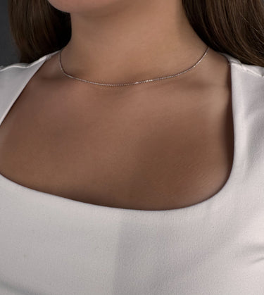 Model wearing Bossa silver chain necklace by Matte, minimalist delicate jewelry