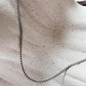 Bossa silver chain necklace by Matte, gold plated, delicate chain on neutral fabric