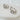 Front view of Braine Hoop Earrings: gold-plated hoops set with oval clear crystal centers