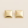 Brume Huggie Earrings, gold square huggie earrings with softly domed pillow shape and polished mirror finish, photographed on white linen background with soft editorial lighting
