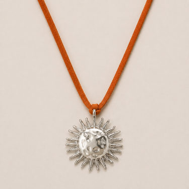 Bumert Necklace silver sun pendant necklace on suede cord featuring radiant sun motif.