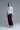Model in Burgundy Wide-Leg Pants, styled with gray sweater and sneakers for a casual chic look.