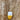 Cambria Necklace by Matte, ceramic pendant in yellow and white on gold chain displayed on wood background
