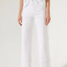 Model wearing Camelia Jeans in white high-rise wide-leg fit.