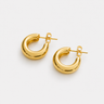 Carda Hoop Earrings featuring polished gold-plated chunky hoop earrings with a smooth rounded silhouette, mirror finish, bold tubular design, secure hinged closure, lightweight feel, and timeless everyday style, displayed on a soft white background.