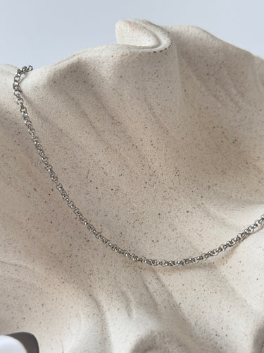Carioca silver chain necklace by Matte, classic round chain on neutral fabric background
