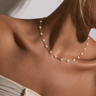 Carroll heart pearl gold necklace worn on model.
