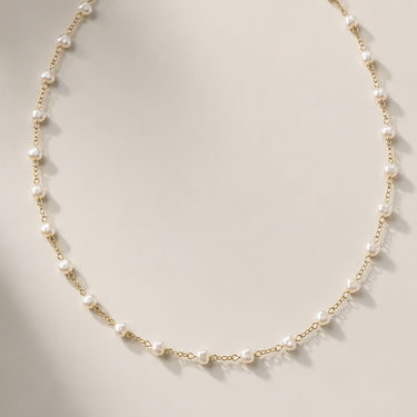 Flat lay of the Carroll pearl layering necklace showing the full chain.