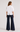 Back view of the Castca white puff-sleeve top styled with dark wide-leg pants.