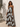 Celani Maxi Dress strapless brown floral maxi dress with oversized cream floral print worn on model showing full length flowy silhouette.