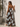 Celani Maxi Dress back view strapless maxi dress with relaxed drape and bold floral print for resort styling.