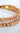 Close-up of gold double row bracelet showing polished beads and sparkling cubic zirconia stones