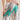 Silver sequin pants with bold green and red lightning bolt detail, high-waisted flared fit, close up