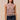 Clotet Top sleeveless neutral crochet-style top worn with black ruffle shorts, showing open-knit texture, straight fit, and fringe hem.
