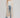 Woman wearing long beige Coavilla Cardigan over white tank top, denim shorts, and brown boots – Matte Clothing